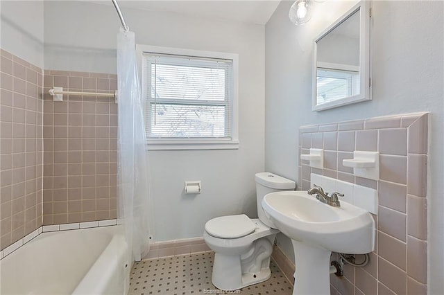 bathroom featuring shower / bath combination with curtain, toilet, and tile walls