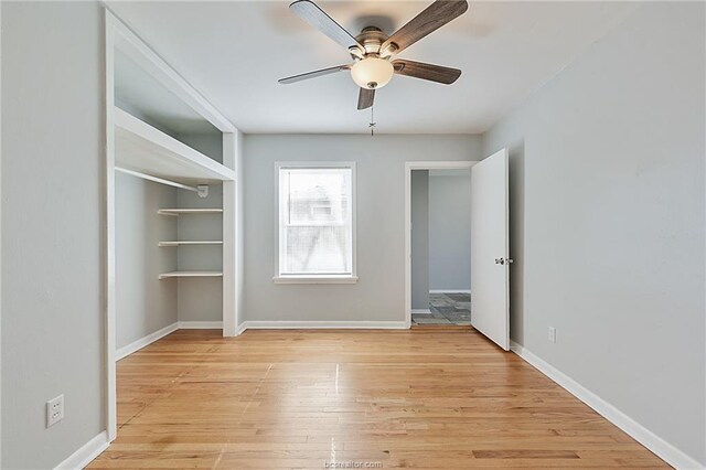 empty room with ceiling fan and light wood-type flooring