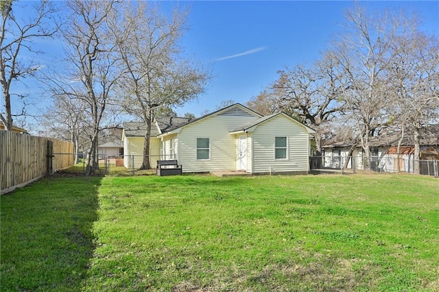 back of property featuring a lawn