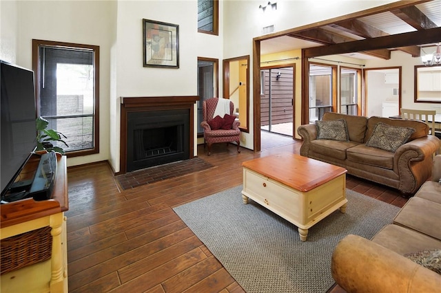 1538 Wolf Run, College Station, TX 77840 - living area featuring dark wood-style flooring, a fireplace with flush hearth, and beamed ceiling