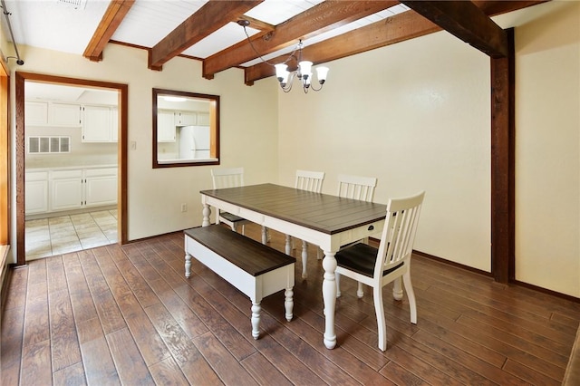 1538 Wolf Run, College Station, TX 77840 - dining room with a chandelier, beamed ceiling, dark wood-type flooring, and baseboards