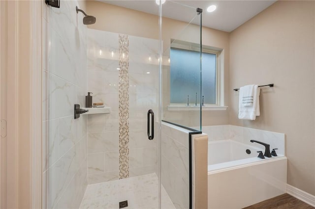 bathroom featuring shower with separate bathtub and hardwood / wood-style floors