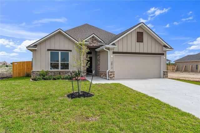 view of front of property featuring a garage and a front lawn