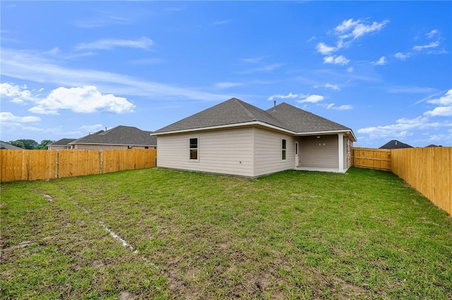 back of property featuring a yard