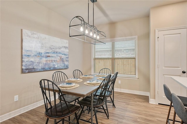 dining space with light hardwood / wood-style flooring