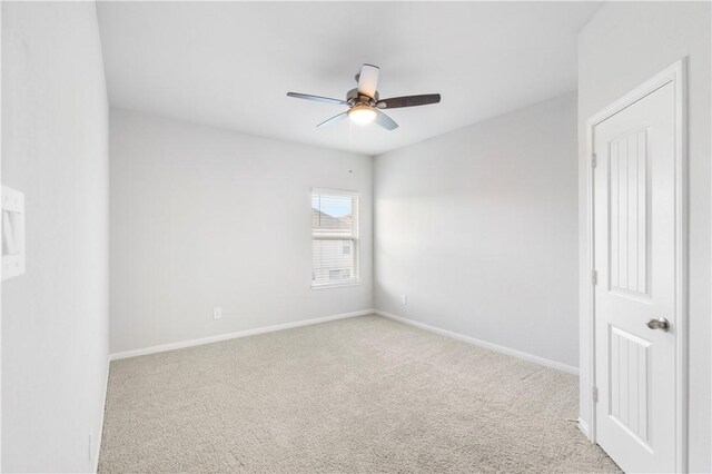 unfurnished room featuring light colored carpet and ceiling fan