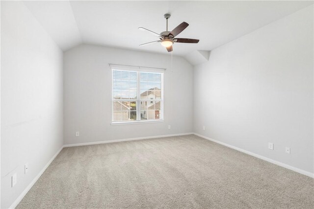 empty room with carpet floors, ceiling fan, and lofted ceiling