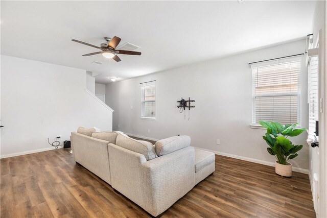 living room with ceiling fan and dark hardwood / wood-style flooring