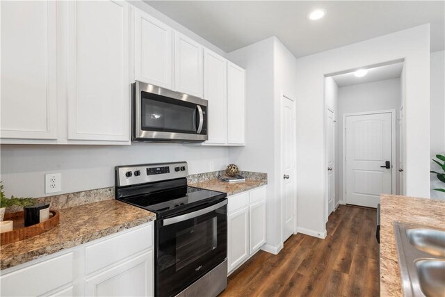 kitchen featuring white cabinetry, dark hardwood / wood-style flooring, sink, and appliances with stainless steel finishes