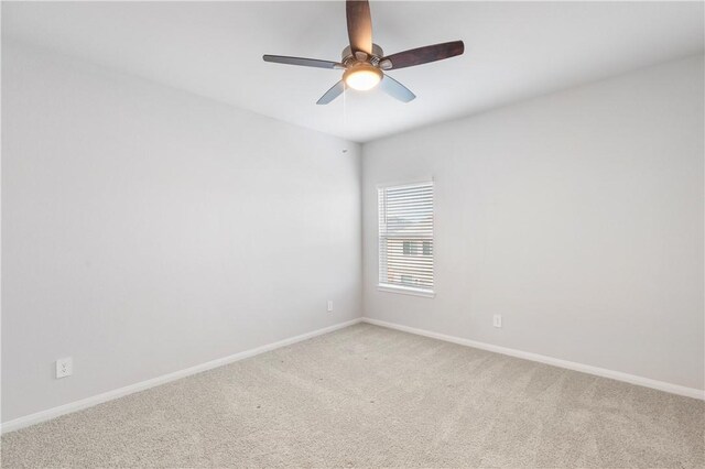 unfurnished room with ceiling fan and carpet