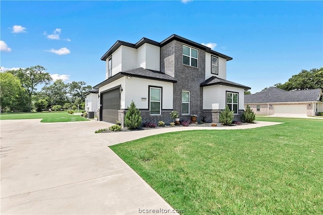 view of front facade featuring a garage and a front lawn