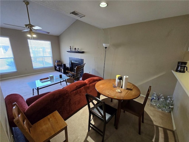 carpeted living room with ceiling fan and lofted ceiling