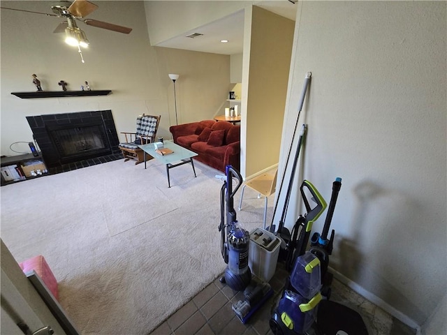 living room featuring tile patterned floors, ceiling fan, and a tile fireplace