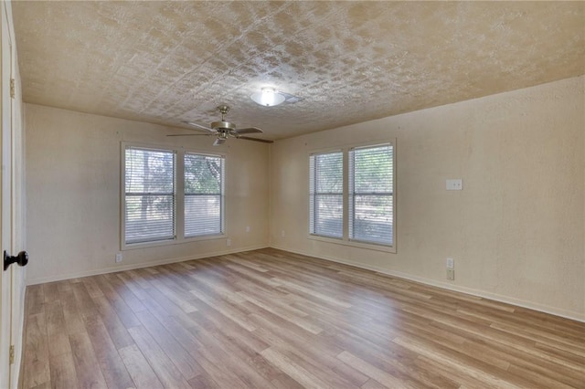 spare room with light wood-type flooring and ceiling fan