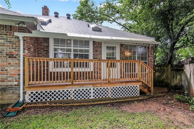 back of property with a wooden deck