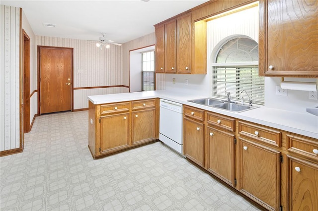 kitchen featuring kitchen peninsula, ceiling fan, sink, and white dishwasher