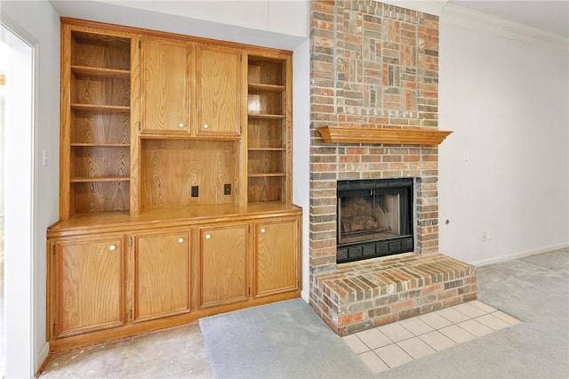 unfurnished living room featuring light colored carpet, a brick fireplace, and crown molding