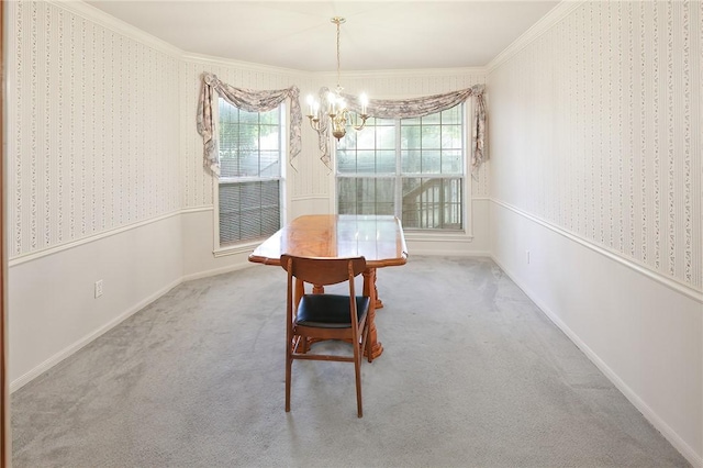 dining room with carpet flooring, crown molding, and a notable chandelier