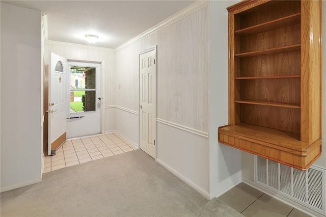 doorway with crown molding and light colored carpet