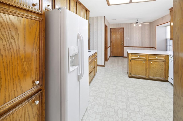 kitchen featuring kitchen peninsula, white appliances, and ceiling fan