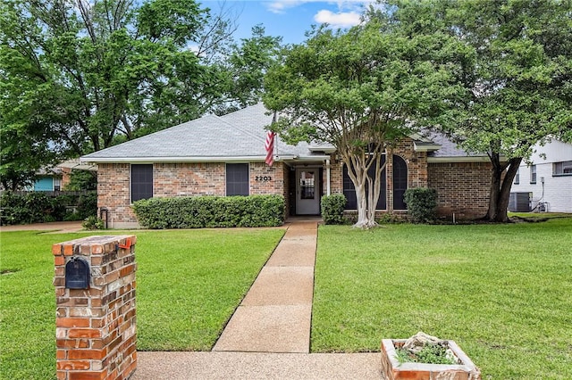 single story home with a front lawn and central AC unit