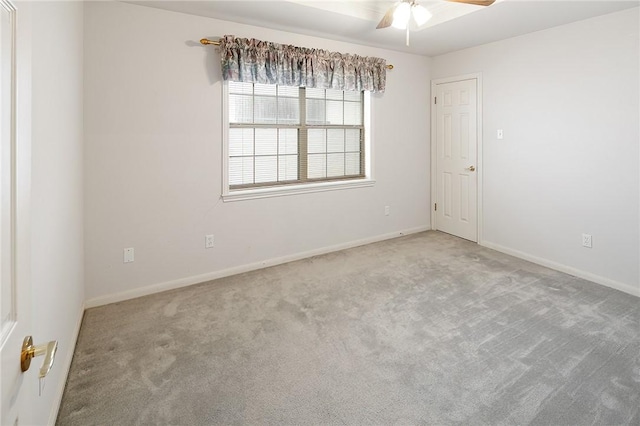 carpeted empty room featuring ceiling fan