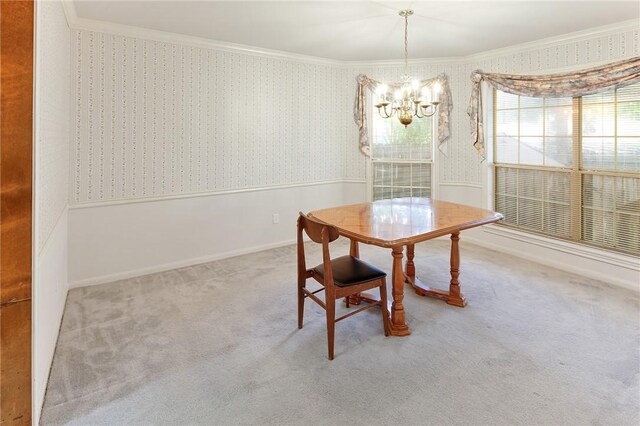 dining space featuring carpet, an inviting chandelier, and crown molding