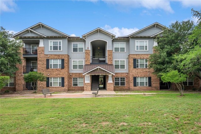 1725 Harvey Mitchell Pkwy S Unit 2433, College Station, TX 77840 - view of front of property with a front yard and brick siding