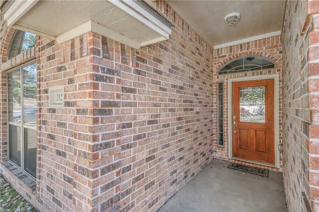 entrance to property with brick siding