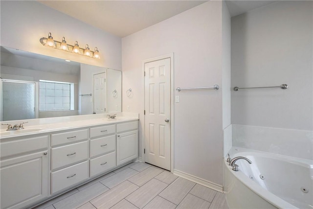 bathroom featuring double vanity, a jetted tub, a sink, and a shower stall