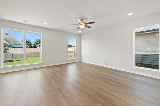 spare room featuring ceiling fan and light hardwood / wood-style floors