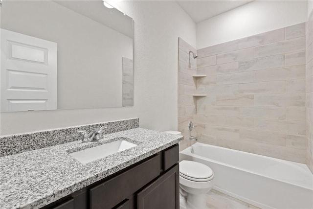 full bathroom featuring tiled shower / bath combo, toilet, and vanity