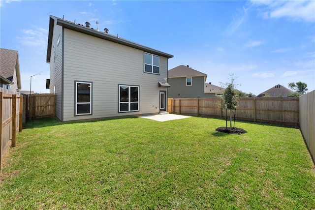 back of property featuring a lawn and a patio area