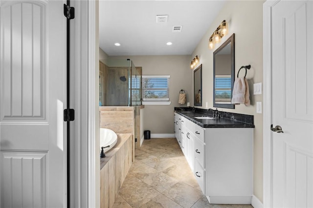 bathroom with vanity and independent shower and bath