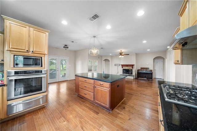 32287 Rochen Rd, Waller, TX 77484 - kitchen featuring appliances with stainless steel finishes, a warming drawer, arched walkways, open floor plan, and recessed lighting