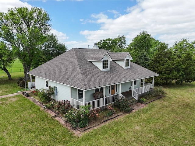 32287 Rochen Rd, Waller, TX 77484 - rear view of house with covered porch, a shingled roof, a lawn, and a chimney