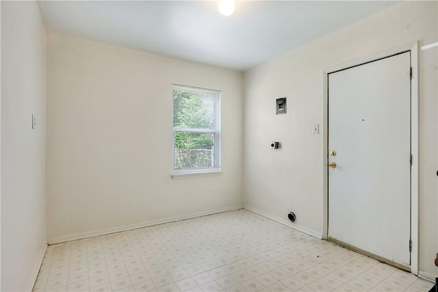 unfurnished room with baseboards and light floors