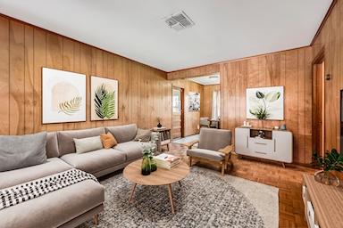 living area with visible vents and wooden walls