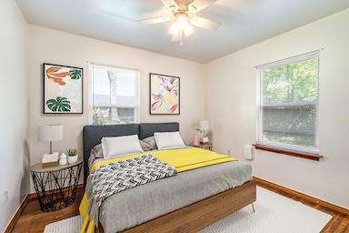 bedroom with baseboards and wood finished floors