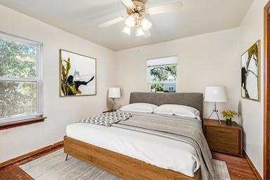 bedroom with baseboards, a ceiling fan, and wood finished floors