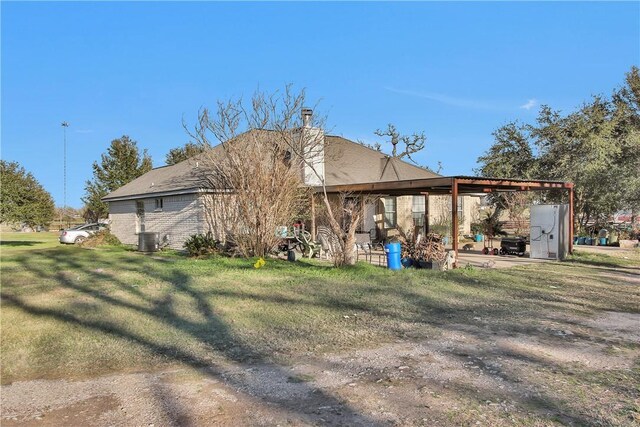 24248 State Highway 6 S, Navasota, TX 77868 - back of property featuring central AC unit and a lawn