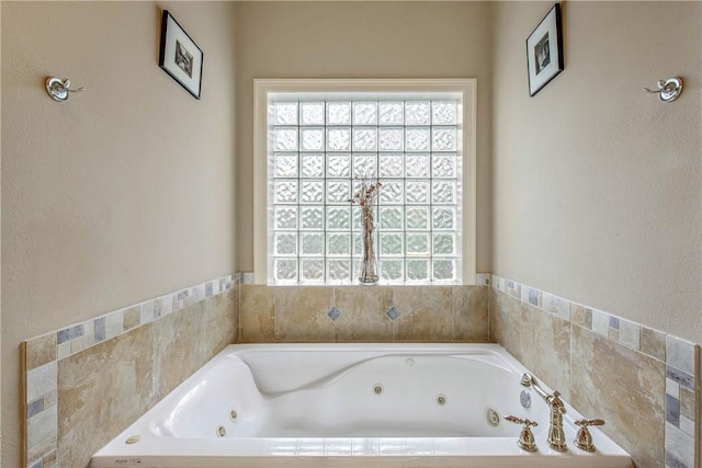 bathroom featuring a wealth of natural light and a bathing tub