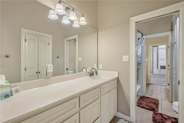 full bathroom featuring a chandelier, vanity, toilet, shower / bath combo, and tile patterned floors