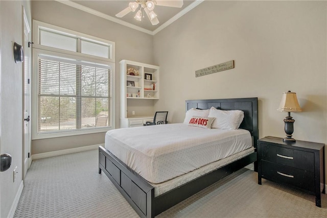 carpeted bedroom featuring ornamental molding and ceiling fan