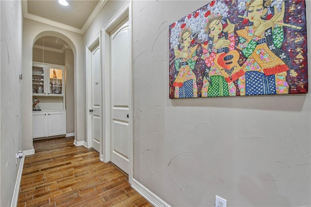 hall featuring ornamental molding and light wood-type flooring