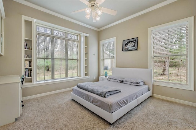 carpeted bedroom featuring ornamental molding and ceiling fan