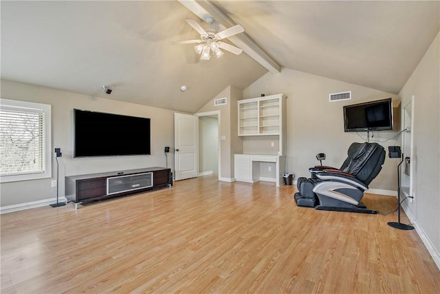 living room with vaulted ceiling with beams, light hardwood / wood-style floors, and ceiling fan