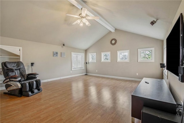 interior space featuring lofted ceiling with beams, ceiling fan, and light wood-type flooring