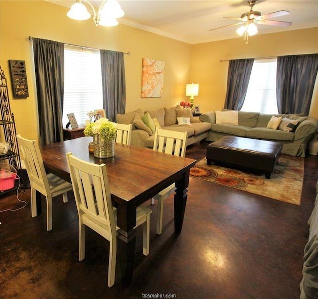 dining room with ceiling fan with notable chandelier, concrete floors, and crown molding