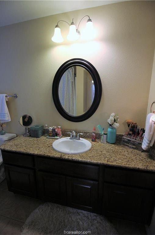 bathroom featuring tile patterned flooring and vanity